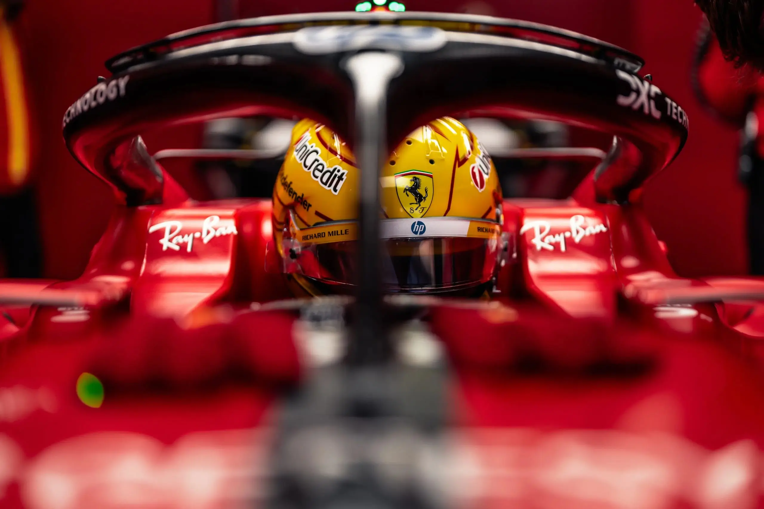 Two Formula 1 drivers’ helmets seen through the halo of a race car