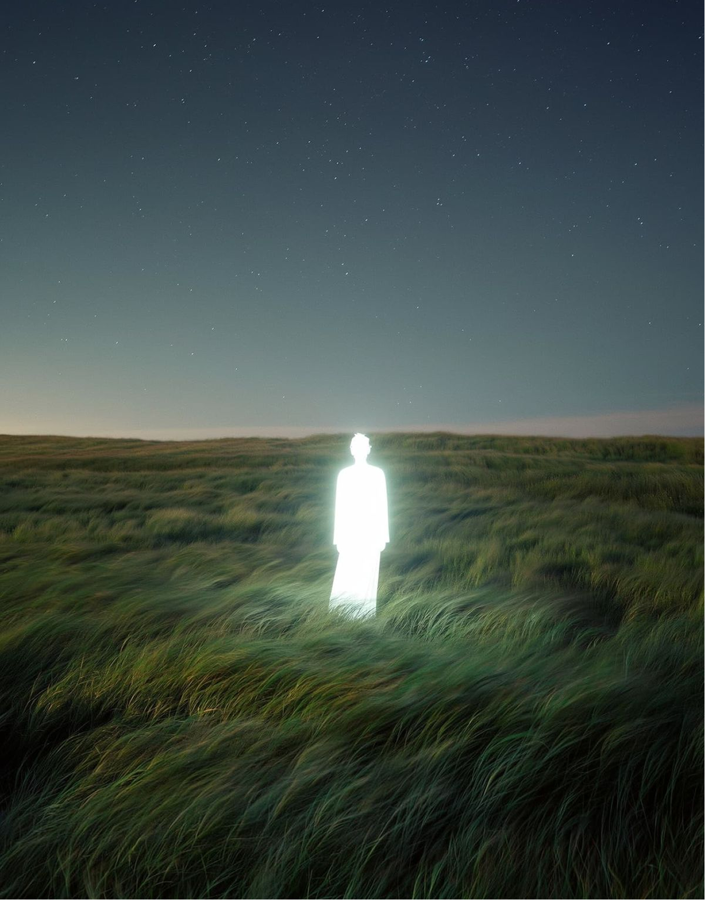 A solitary figure standing beneath the horizon of Earth